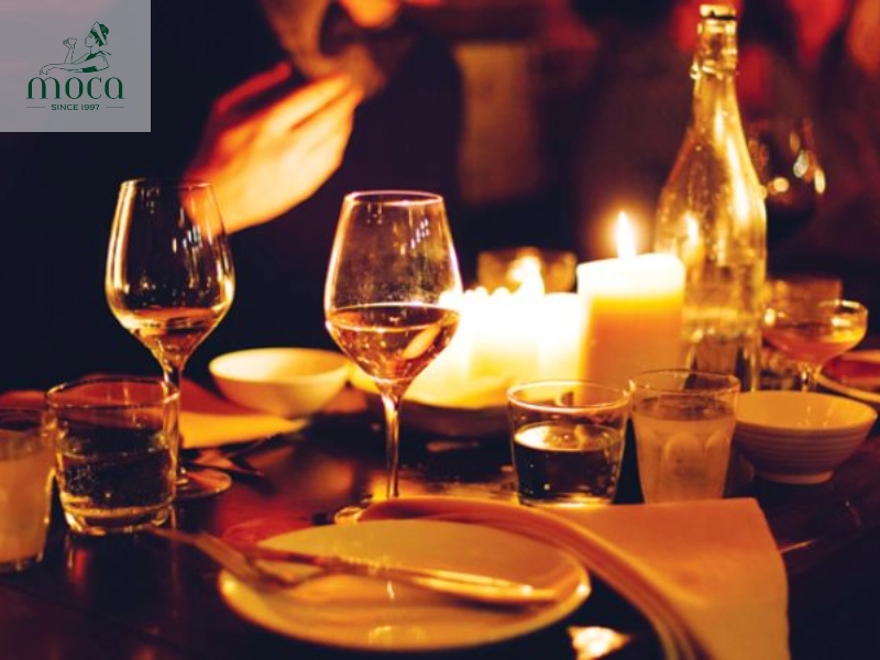 An intimate table for two bathed in candlelight, overlooking a serene garden—where elegance meets romance.