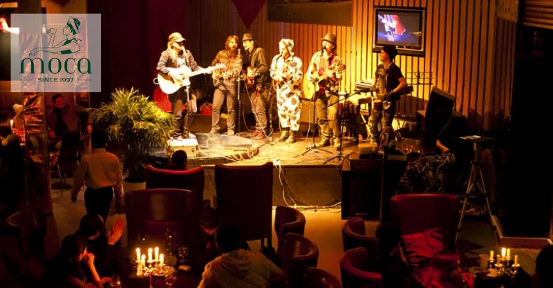 A refined fine dining setting with live piano or small ensemble, creating an intimate, elegant atmosphere.