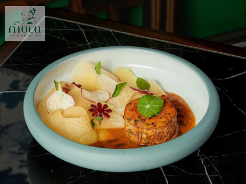 A dish presented with a clear focal point, using negative space and flow to guide the visual journey.