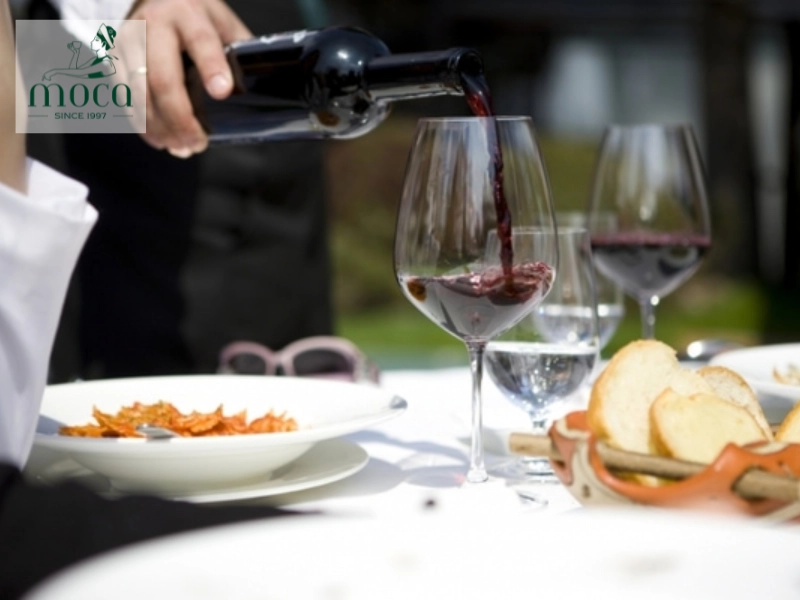 Precision in every pour — the ritual of wine service enhances both taste and tradition.