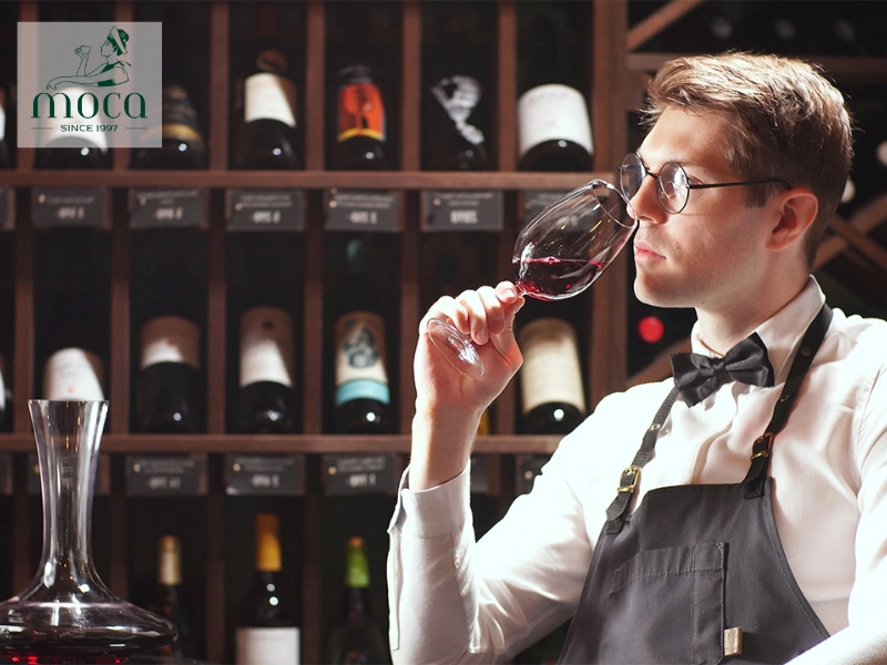 A sommelier engages warmly with guests, crafting a personalized wine experience.
