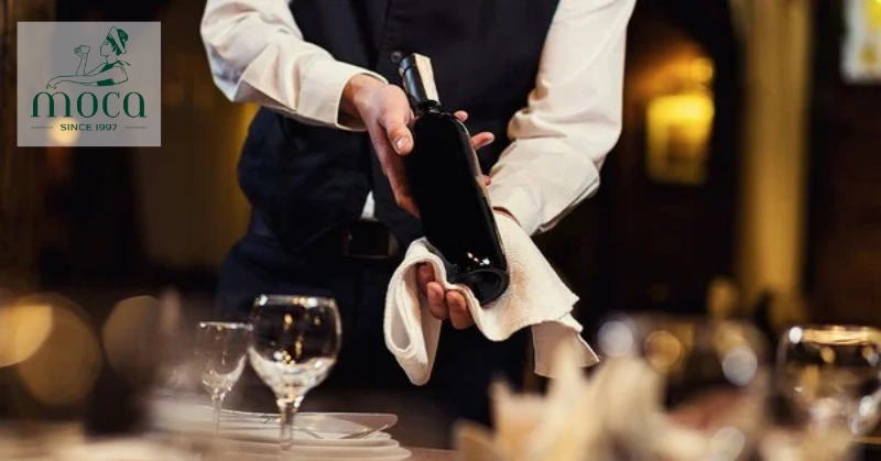 Offering wine with grace — every pour is a gesture of respect, elegance, and shared celebration.